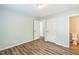 Bedroom features fresh paint, new wood-look flooring, and en-suite half bathroom at 605 Sexton Ave, Zebulon, NC 27597