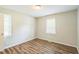 Bedroom with new wood floors and bright windows allowing natural light at 605 Sexton Ave, Zebulon, NC 27597