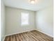Bedroom showcasing new wood floors and a bright window with natural light at 605 Sexton Ave, Zebulon, NC 27597