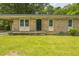 Front view of a single story brick house featuring a covered porch and well-maintained lawn at 605 Sexton Ave, Zebulon, NC 27597