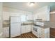 Updated kitchen featuring white cabinets, granite countertops, and modern appliances at 605 Sexton Ave, Zebulon, NC 27597