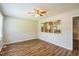 Bright living room featuring wood flooring, a ceiling fan, and natural light at 605 Sexton Ave, Zebulon, NC 27597