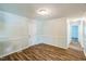Open living room with fresh paint, updated wood-look flooring, and ample lighting at 605 Sexton Ave, Zebulon, NC 27597