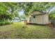 A home's grassy backyard with a wood deck and beige vinyl siding at 611 Rowland St, Henderson, NC 27536