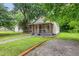 Inviting single story home with a screened in porch and a driveway leading to the backyard at 611 Rowland St, Henderson, NC 27536