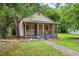 Single story home with screened in porch and rock border landscaping in the front yard at 611 Rowland St, Henderson, NC 27536