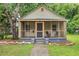 Charming single story home featuring a cozy screened porch and landscaped front yard with rock border at 611 Rowland St, Henderson, NC 27536