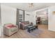 Open floor plan of the living room which flows into the kitchen with modern decor and wood floors at 611 Rowland St, Henderson, NC 27536