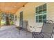 Relaxing screened in porch with neutral colors and lots of natural light; perfect for enjoying the outdoors at 611 Rowland St, Henderson, NC 27536