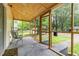 Relaxing screened in porch with neutral colors and lots of natural light; perfect for enjoying the outdoors at 611 Rowland St, Henderson, NC 27536
