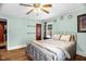 Comfortable bedroom with wood floors, ceiling fan, natural light, and neutral colors at 625 Columbia Ave, Burlington, NC 27217