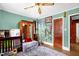 room with blue patterned rug, green walls, brown closet, and baseball decor at 625 Columbia Ave, Burlington, NC 27217
