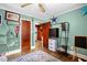 View into hallway from bedroom with hardwood floors and baseball decor at 625 Columbia Ave, Burlington, NC 27217