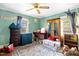 Bright bedroom with green walls and ceiling fan plus a closet and cushioned storage bench at 625 Columbia Ave, Burlington, NC 27217