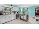 Eat-in kitchen area showcasing an eat-in bar, stainless steel appliances, and natural light at 625 Columbia Ave, Burlington, NC 27217