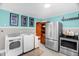 Eat-in kitchen features laundry appliances and access to stainless steel refrigerator and electric range at 625 Columbia Ave, Burlington, NC 27217