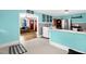 Eat-in kitchen area with retro blue walls and access to living room; shows the stainless steel refrigerator at 625 Columbia Ave, Burlington, NC 27217