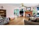 Cozy living room with hardwood floors, fireplace, ceiling fan, and blue accents with an archway leading to another room at 625 Columbia Ave, Burlington, NC 27217