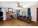 Warm and inviting living room with hardwood floors, a brick fireplace, and large windows providing ample natural light at 625 Columbia Ave, Burlington, NC 27217