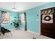 Bright sitting room with sky blue walls, large windows, indoor plants, and wood accents at 625 Columbia Ave, Burlington, NC 27217