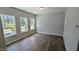 Bright bedroom featuring hardwood floors, large windows offering views of the surrounding greenery, and neutral paint at 691 Bandon Aly, Cary, NC 27513