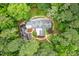 Overhead view of a secluded property surrounded by verdant trees and meticulous landscaping at 708 October Woods Rd, Chapel Hill, NC 27516