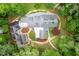 Aerial view of a sprawling home featuring lush landscaping, patio and greenery at 708 October Woods Rd, Chapel Hill, NC 27516