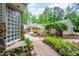 Image shows the tranquil backyard with gravel and stone pathways and mature plants at 708 October Woods Rd, Chapel Hill, NC 27516
