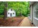 Exterior view of the detached studio complemented by a landscaped pathway at 708 October Woods Rd, Chapel Hill, NC 27516