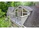Exterior shot of upper level balcony with decorative iron railing and wooded backdrop at 708 October Woods Rd, Chapel Hill, NC 27516