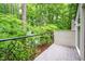 View from balcony with decorative iron railing looking onto lush green trees at 708 October Woods Rd, Chapel Hill, NC 27516