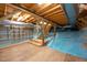 Spacious unfinished basement featuring exposed beams, wood steps and existing ductwork at 708 October Woods Rd, Chapel Hill, NC 27516