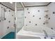 Bathroom with tub and shower combo, white tile and colorful accent tiles at 708 October Woods Rd, Chapel Hill, NC 27516