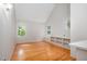 Bright bedroom with hardwood floors, vaulted ceiling and built-in shelving at 708 October Woods Rd, Chapel Hill, NC 27516