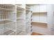 Walk-in closet equipped with shelves and wire baskets for ample storage at 708 October Woods Rd, Chapel Hill, NC 27516