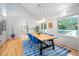 Bright dining room with modern lighting, hardwood floors, and large windows at 708 October Woods Rd, Chapel Hill, NC 27516