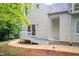Exterior view of the home featuring a porch and sliding glass door, complemented by a landscaped pathway at 708 October Woods Rd, Chapel Hill, NC 27516