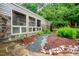 Charming home exterior with stone accents, modern windows, and lush landscaping at 708 October Woods Rd, Chapel Hill, NC 27516