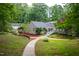 Exterior shows yard featuring winding walkway, lush greenery, and unique rooflines at 708 October Woods Rd, Chapel Hill, NC 27516