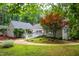 Exterior shows yard featuring winding walkway, lush greenery, and mature trees at 708 October Woods Rd, Chapel Hill, NC 27516