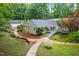 Exterior shows yard featuring winding stone walkway, lush greenery, and multiple structures at 708 October Woods Rd, Chapel Hill, NC 27516