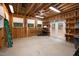 Spacious garage interior with natural wood framing, ample shelving, and a door leading to the exterior at 708 October Woods Rd, Chapel Hill, NC 27516