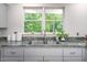 Kitchen featuring granite countertops, a stainless steel sink, and natural light at 708 October Woods Rd, Chapel Hill, NC 27516