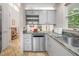 Modern kitchen features grey cabinets, green marble countertop, stainless steel appliances, and tile floors at 708 October Woods Rd, Chapel Hill, NC 27516