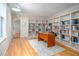 Bright office featuring built-in bookshelves, modern desk, and hardwood flooring at 708 October Woods Rd, Chapel Hill, NC 27516