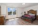 Bright bedroom with large window, hardwood floors, and ample space, creating a peaceful retreat at 71 Nolan Ct, Lillington, NC 27546