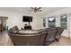 Comfortable living room with hardwood floors, a ceiling fan, and a large leather sectional at 71 Nolan Ct, Lillington, NC 27546