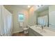 Well-lit bathroom features a shower with curtain, toilet and a stylish vanity with mirror at 729 Lorentello Cir, Hillsborough, NC 27278