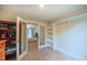 Bright bedroom featuring carpet floors, a closet, and a bookcase, with a view into the Primary bedroom at 729 Lorentello Cir, Hillsborough, NC 27278