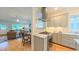 Open-concept kitchen featuring stainless steel appliances seamlessly flowing into the living area at 729 Lorentello Cir, Hillsborough, NC 27278
